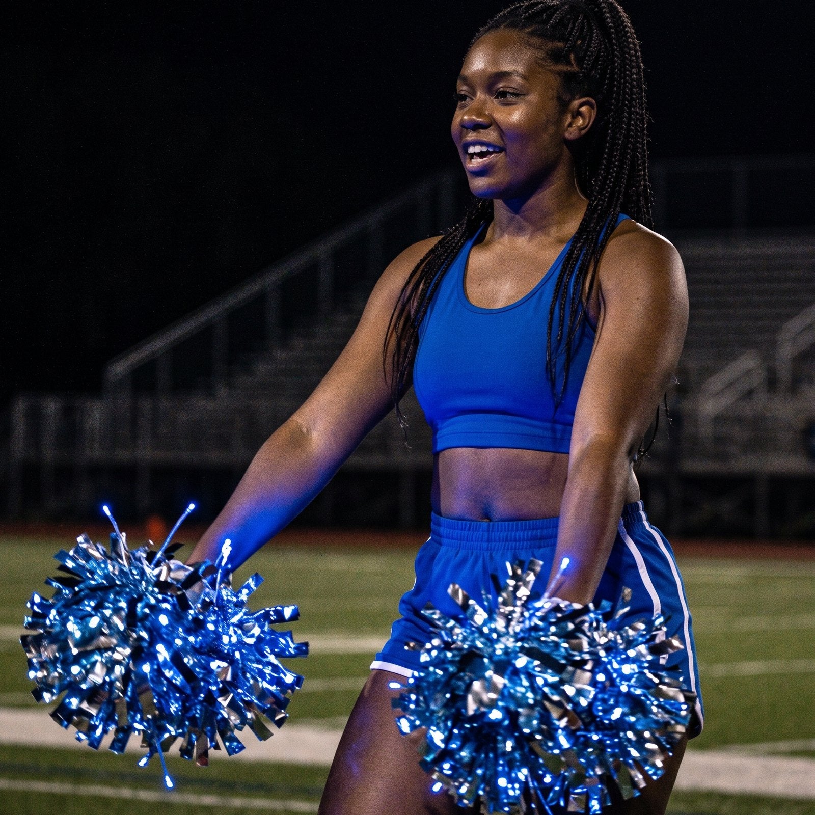 Neon Cowboys LED light-up pom poms in blue: LED diodes through each pom, the baton handle hidden in her grip