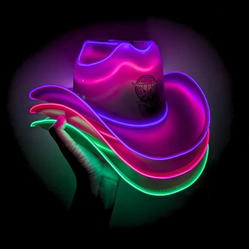 Three stacked light up cowboy hats glowing pink, green and purple held against a black studio background, this LED cowboy hat and neon cowboy hat 3 pack of glow in the dark cowboy hats is made for music festivals, country concerts, rodeos and bachelorette parties, Neon Cowboys