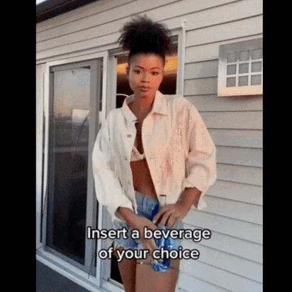 Woman wearing drink holster at festival demonstrating how to keep drinks hands-free while dancing at concerts