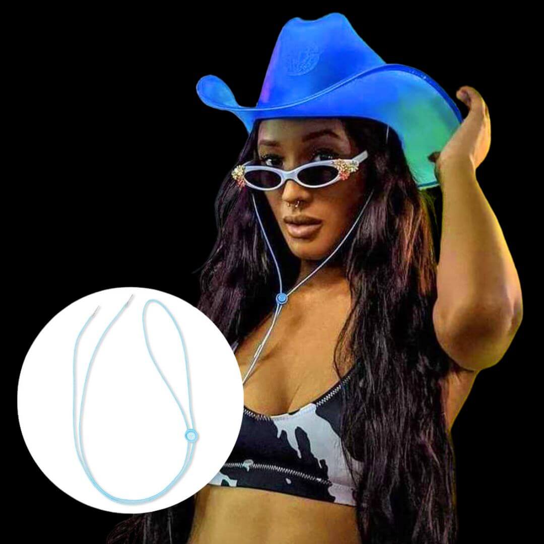 Woman adjusting light up blue cowboy hat with elastic chin strap at music festival, showing inset detail of durable secure fit accessory for rave dancing