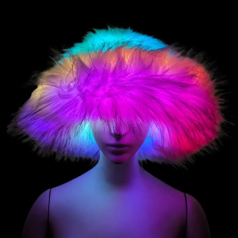 Mannequin wearing a soft plush furry bucket hat glowing rainbow pink, teal and orange on black, a Tyler Lambert x Neon Cowboys LED furry bucket hat with built-in color-changing lights for music festivals, rave outfits and nightclub events, Neon Cowboys