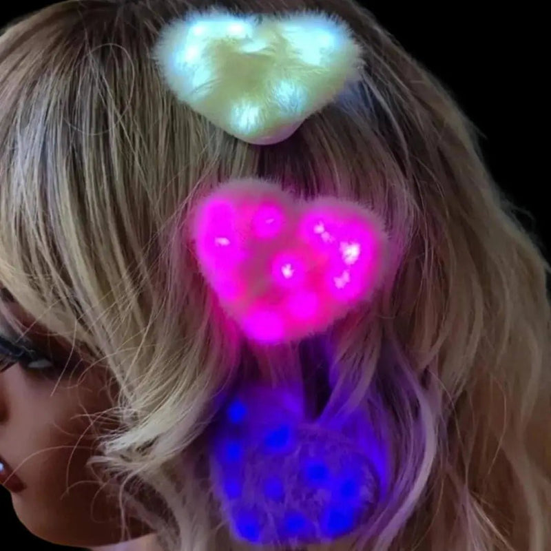 Three Neon Cowboys LED fuzzy heart hair clips glowing white, pink and blue pinned in wavy blonde hair, illuminated kawaii light-up hair accessories in a 3 pack for festivals, raves, cosplay events, birthday celebrations and Y2K looks, Neon Cowboys