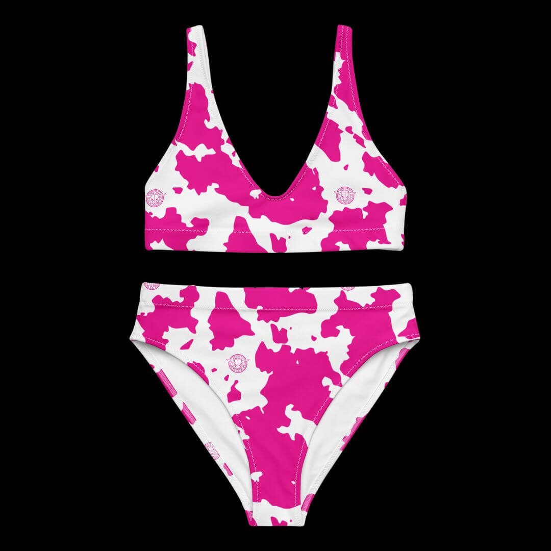 Pink cow print high-waisted bikini top and bottom laid flat showing pattern detail perfect for summer vacation outfits and festival pool parties with unique animal print style for photos