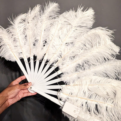 White feathered fan held in hand showing non-illuminated design - Elegant silk-soft feather accessory for daytime festival fashion, costume parties, wedding photo booths, and theatrical performances