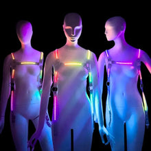 Group of friends displaying multicolor remote controlled LED harnesses showing different lighting patterns perfect for nightclub outfits rave wear and festival fashion accessories and Mardi Gras