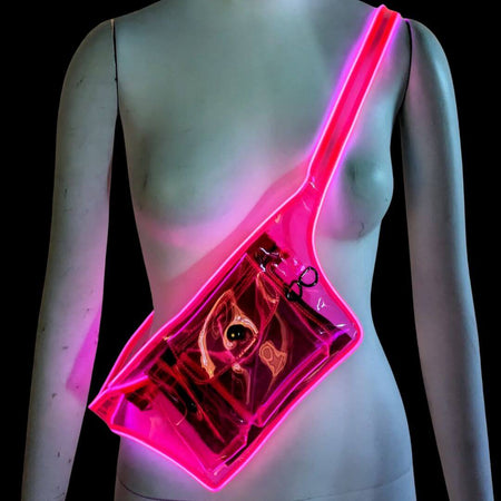 Woman wearing pink illuminated fanny pack with clear transparent pouch perfect for music festivals stadium events and nightclub accessories