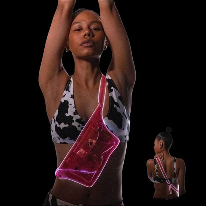 Woman dancing with red light up fanny pack showing movement effect for nightlife parties and dance floor visibility
