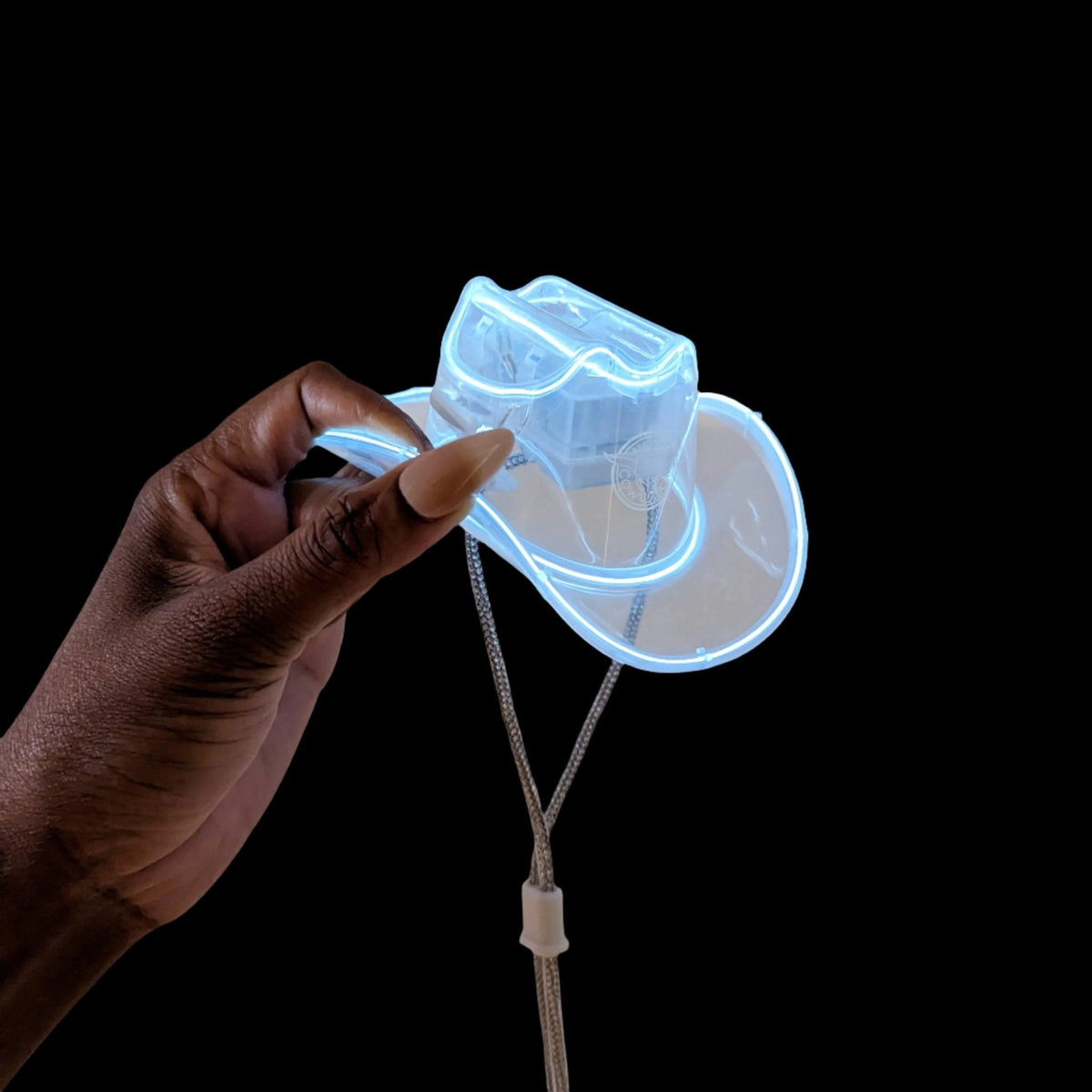 Glowing white light up mini neon cowboys hat for country music festivals and line dancing events creating eye catching western themed party accessories at night