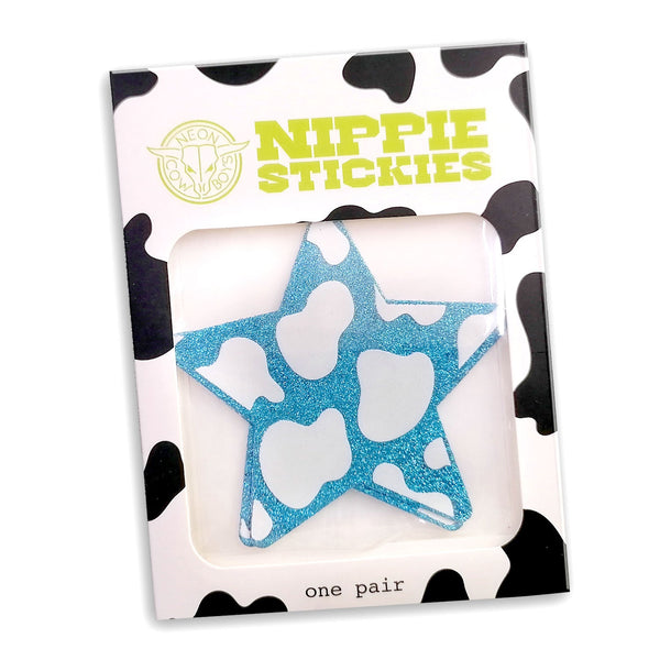 Packaged star-shaped nipple stickies with cow print packaging showing blue holographic design for rodeo outfits and country western parties