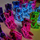 Rainbow collection of light up transparent boots in pink blue green and purple perfect for festival season wardrobe planning and group event coordination designed by Neon Cowboys high end glowing shoes