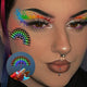 Woman wearing rainbow LED face sticker at pride parade with LGBTQIA+ festival glowing cheek accent for music festival and concert makeup
