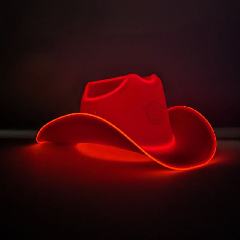 Red LED cowboy hat with bright LED lights, a glowing red light up cowboy hat lit against a dark studio backdrop, neon cowboy hat perfect for luxury party celebrations, VIP events, western costume fashion and rave nights, Neon Cowboys