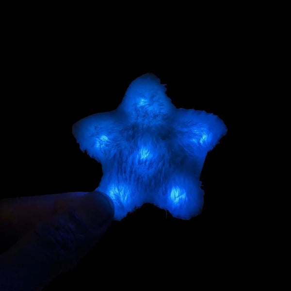Blue LED star fuzzy hair clip close-up - Bright illuminated star-shaped hair accessory for winter wonderland themes, galaxy costumes, mermaid outfits, and nighttime beach parties