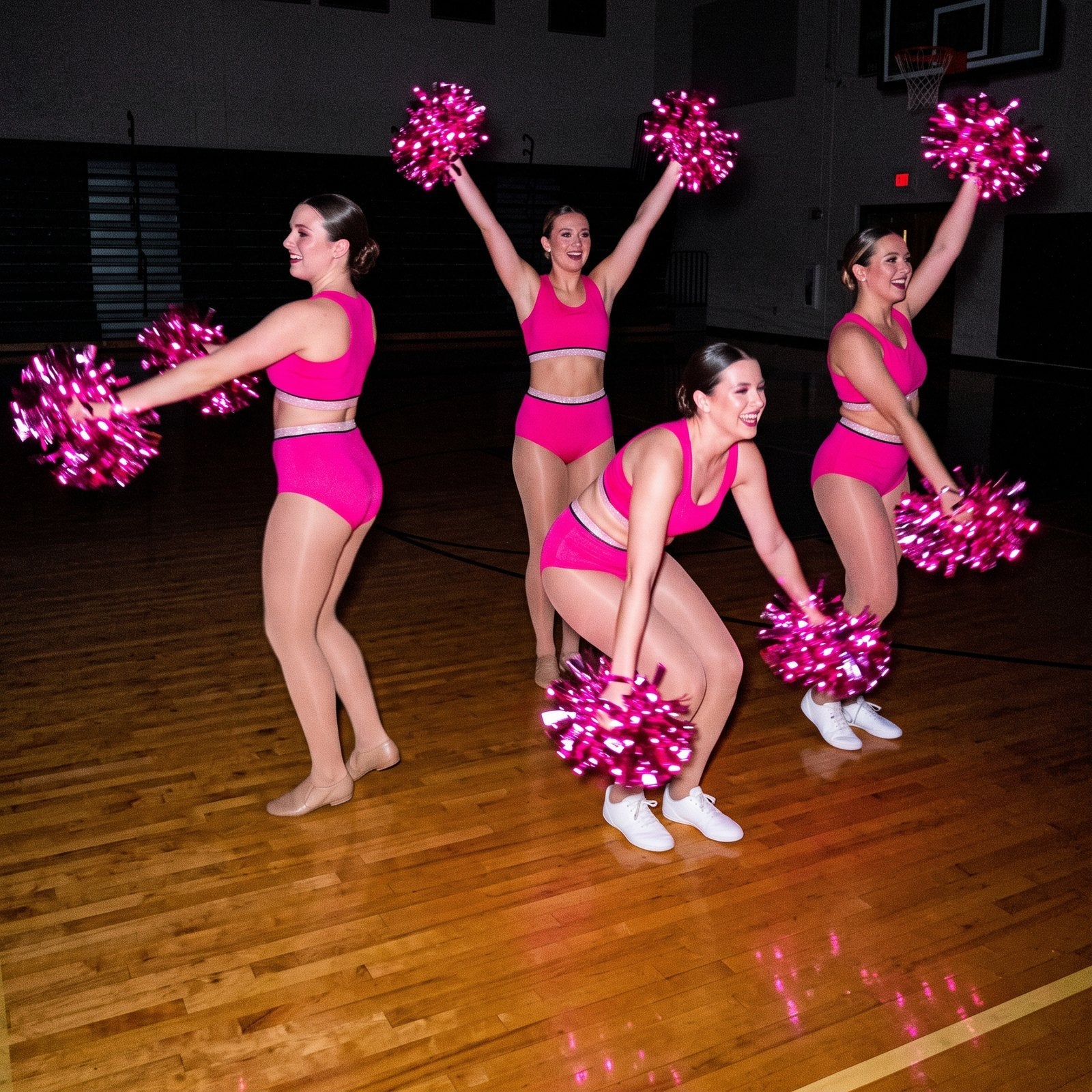 Dance squad in matching hot pink with a full team set of light-up cheer pom poms