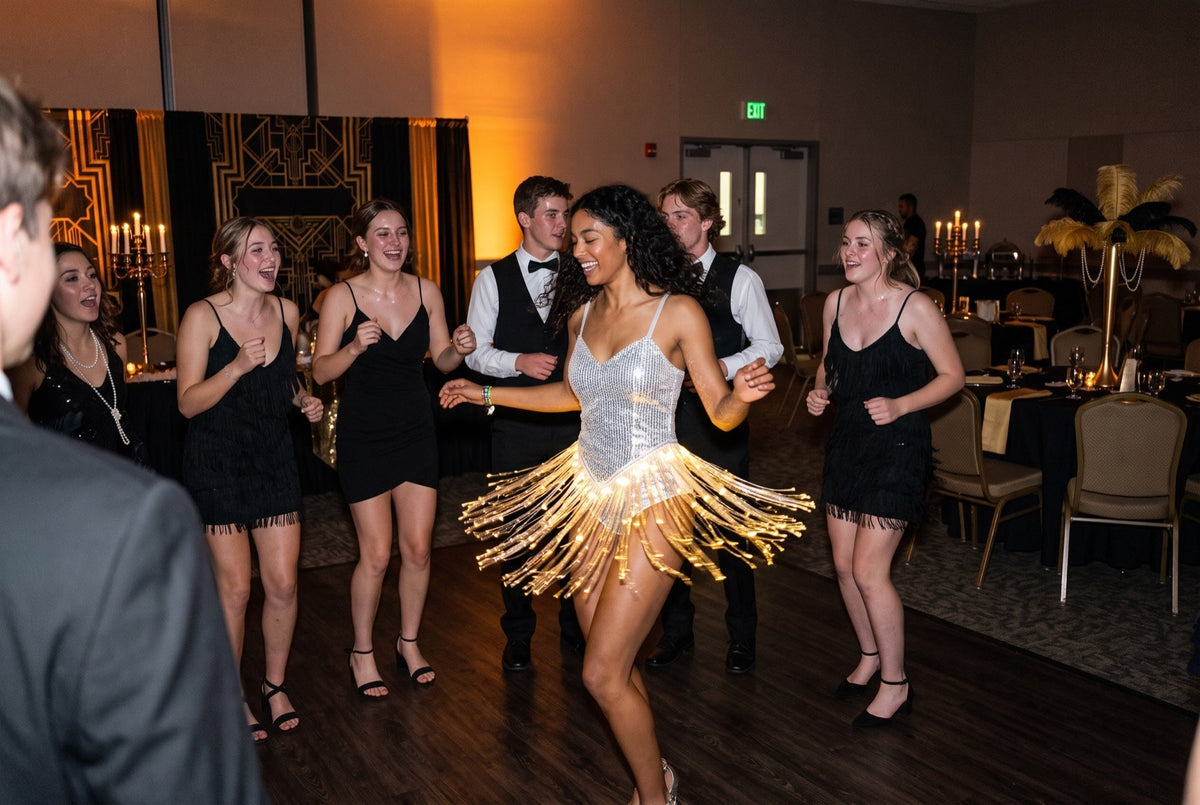 Light up LED fringe dress glowing gold at a Great Gatsby art deco themed formal