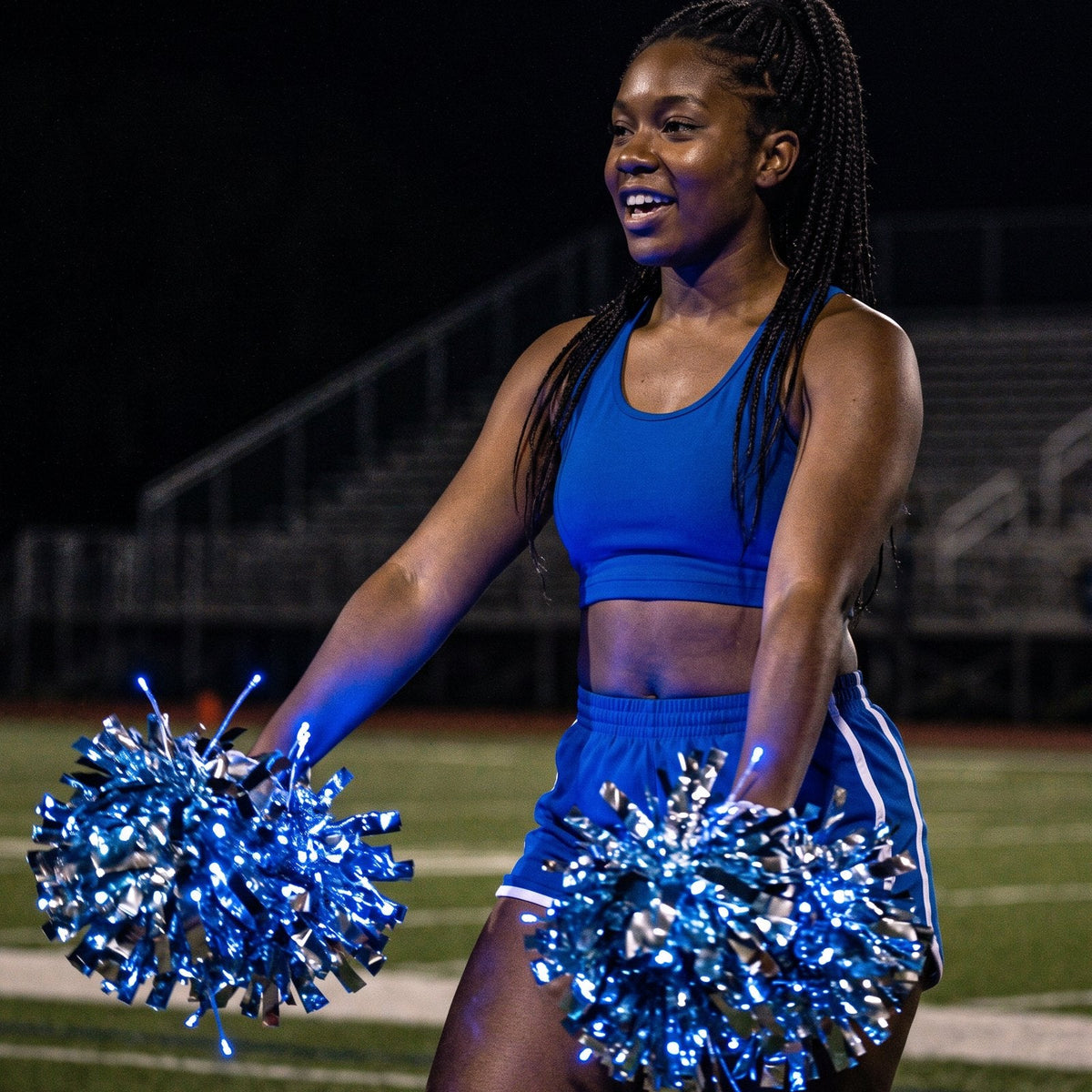 Neon Cowboys LED light-up pom poms in blue: LED diodes through each pom, the baton handle hidden in her grip