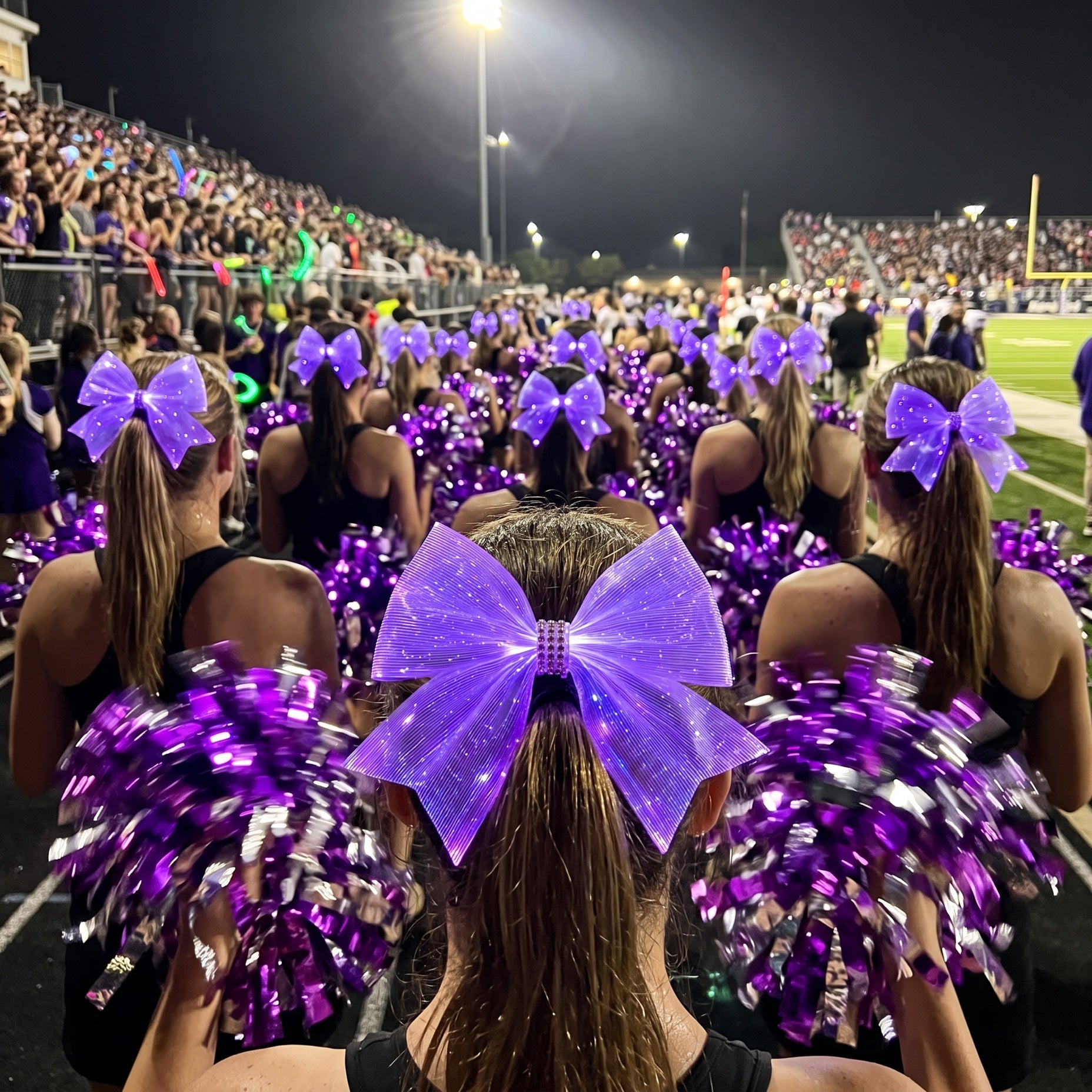 Light-up cheer bows for teams: LED bows glowing purple on a dance team's high ponytails with pom poms at a night game