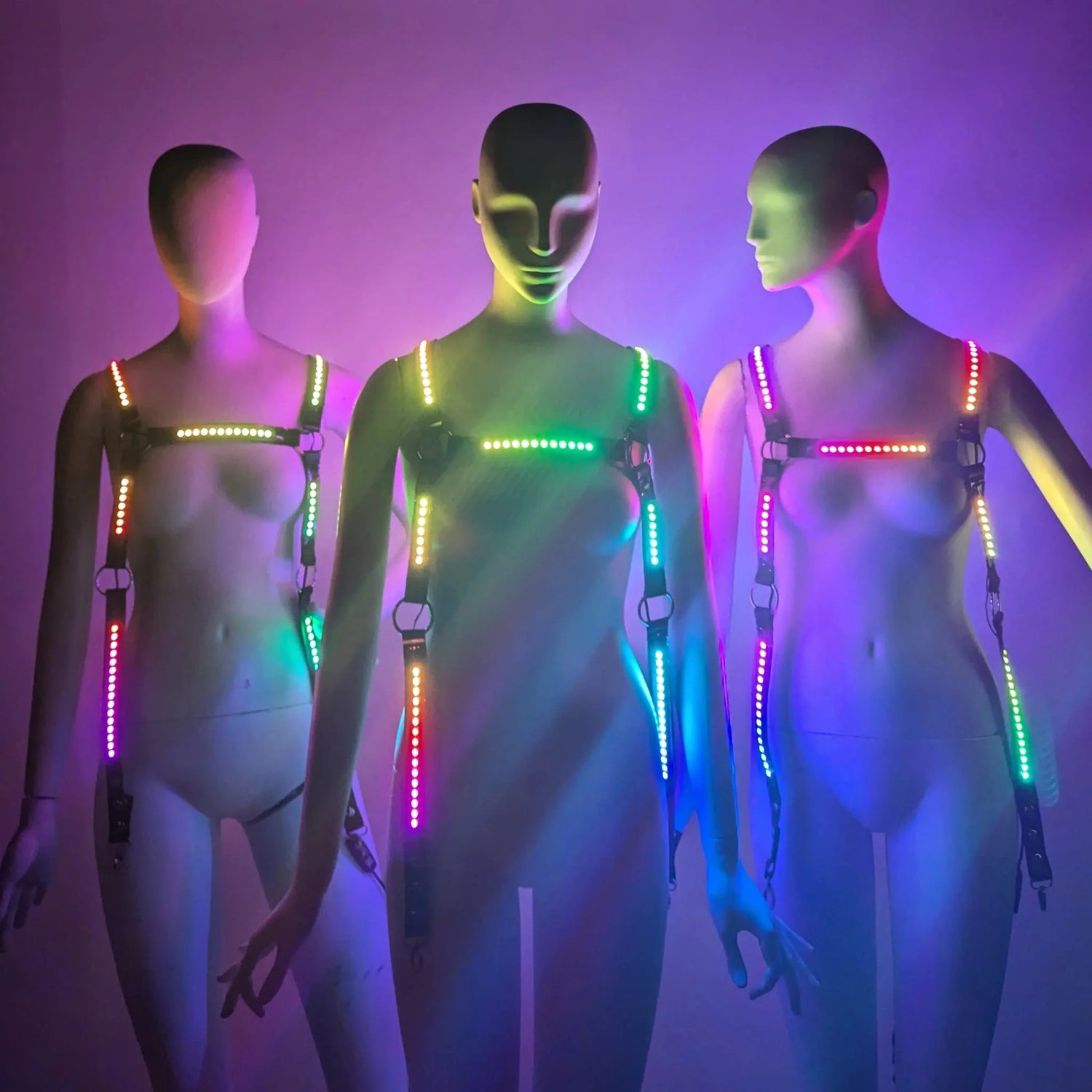 Group of friends wearing colorful LED harnesses displaying multiple lighting color options and patterns for versatile festival and stage performance wear for burlesque professional dancers