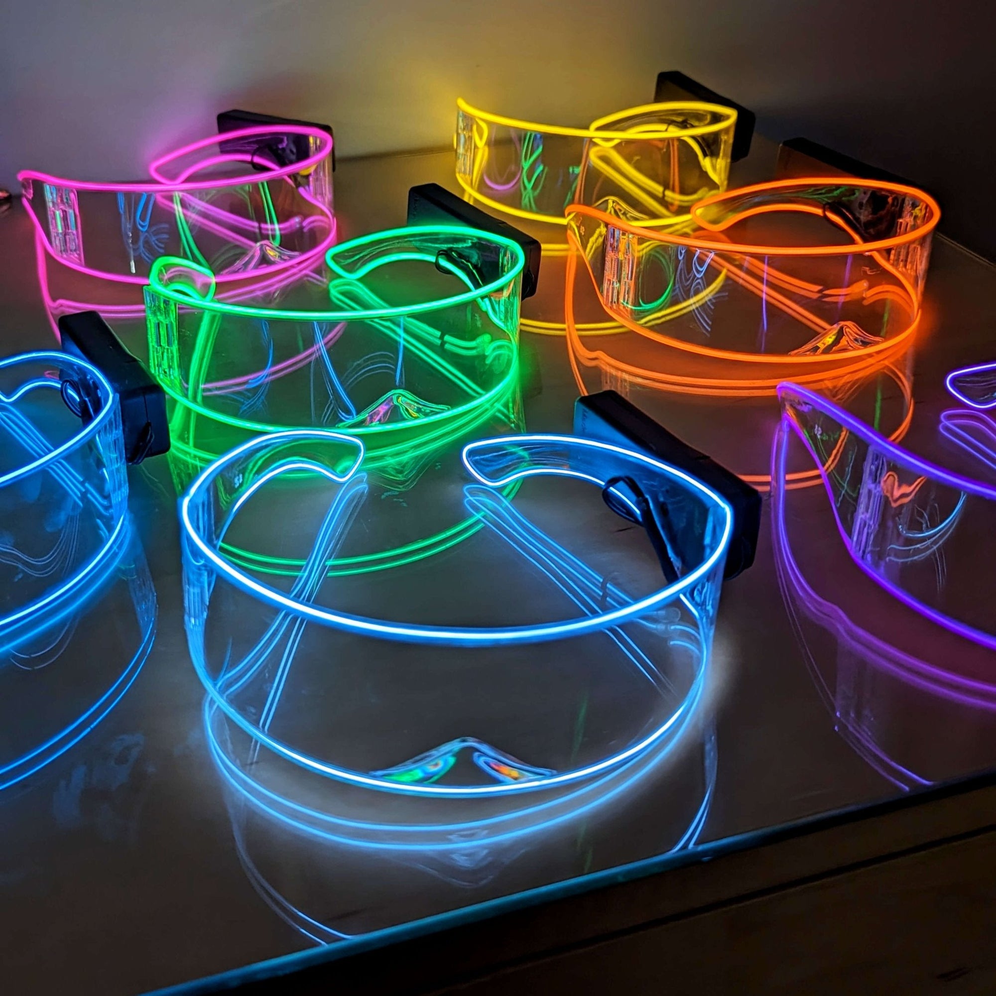 Collection of multicolored rainbow LED transparent cyber glasses - Bulk ordering option of illuminated futuristic eyewear for corporate events, LGBTQIA+ pride parades, tech conventions, and group costumes