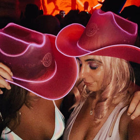 Pink LED cowgirl hats glowing bright for female friends matching party costumes festival outfits and celebration accessories