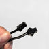 Hand holding Two Prong Inverter connector detail - Close-up of connection points for light-up accessories and star crossbody purse