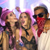 Three friends wearing pink LED cowboy hats at nighttime event - Glowing western-style headwear for music festivals, girls' night out, country bars, western-themed weddings, and summer beach parties