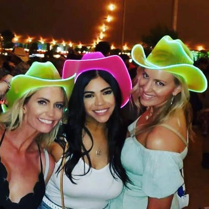Women wearing LED cowboy hats at country-themed event - Yellow and pink illuminated western headwear for line dancing nights, country music festivals, state fairs, rodeo after-parties, and western-themed birthdays