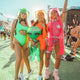 Group of women in neon bodysuits wearing LED cowboy hats at outdoor festival - Bright colored light-up western headwear for Coachella, EDM festivals, costume parties, pride events, and desert gatherings