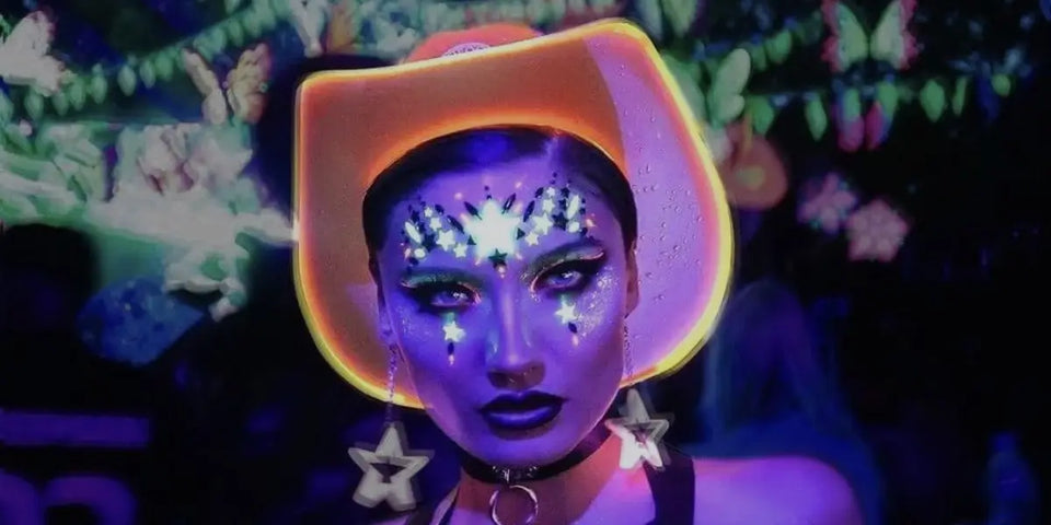 Neon Cowboys light up LED Cowboy hat in orange on woman at a Halloween Rave Party night club scene