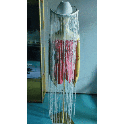 Oversized floor-length LED fringe tassel cowboy hat by Neon Cowboys on a white mannequin, long silver fringe falling to the floor, an avant-garde light-up hat for stage performers, dancers, drag and costume looks