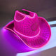 Pink rhinestone LED cowboy hat in purple lighting - Premium illuminated designer piece for runway shows, fashion photography, album covers, and celebrity stylists