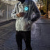 Man walking at dusk wearing light-up horse jacket with glowing animated design showing 18+ hours of rechargeable illumination for nighttime events
