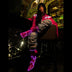 Animated Starlight Fringe Jacket, woman at a bar in a pink LED star fringe jacket with glowing pink light-up cowboy boots and ripped jeans, an led fringe jacket and disco cowgirl stagewear for go-go dancers, bachelorette parties and music festivals, Neon Cowboys
