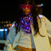 Animated Starlight Fringe Jacket, woman in pink LED sunglasses and a glowing purple bandana with a white LED star fringe jacket by the river at night, an led fringe jacket and light up jacket stagewear for rave performers, festivals and EDM concerts, Neon Cowboys
