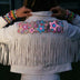 Animated Starlight Jacket with Fringe, back view of a person in a cream fringe jacket with glowing pink and blue LED light-up stars, an led fringe jacket and light up jacket stagewear for festival dancers and burlesque performers at raves, EDM concerts and Pride, Neon Cowboys