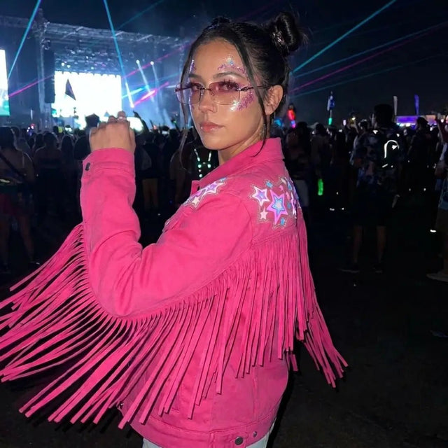 Animated Starlight Jacket with Fringe, woman at a night rave festival with laser lights in a pink LED star fringe jacket and sunglasses, an led costume and light up jacket stagewear for rave performers, EDM concerts, Coachella and EDC, Neon Cowboys