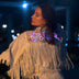 Animated Starlight Jacket with Fringe, woman in a white LED fringe jacket with glowing pink and blue light-up stars across the back at night, an led fringe jacket and light up jacket for go-go dancers, festival dancers and stagewear at raves, EDM concerts and Coachella, Neon Cowboys