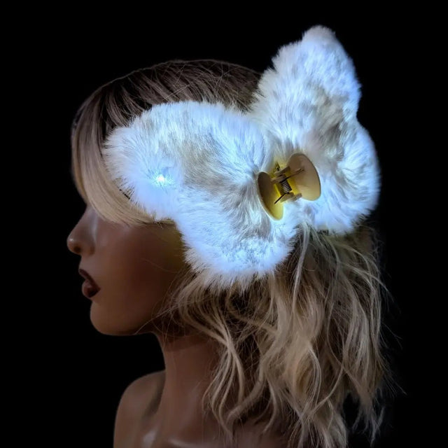 Side profile of woman wearing blue fuzzy butterfly hair clip - Versatile light-up hair accessory styling example for concerts, birthday celebrations, themed parties, and retro fashion statements