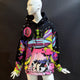 Front view of Day at the Farm hoodie on woman showing colorful UFO cow design ideal for music festival fashion and eye-catching Area 51 streetwear styles