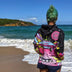 Person wearing Day at the Farm alien cow hoodie at beach party showcasing versatile festival clothing for outdoor summer events and coastal celebrations