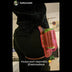 Woman wearing pink drink holster on belt showing hands-free festival accessory for concerts and outdoor events