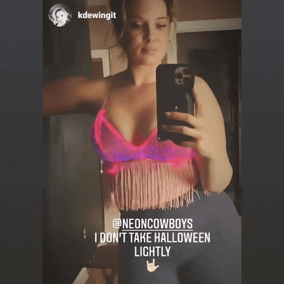 Close-up of pink light up fringe bralette with Instagram caption highlighting popularity at festival events and eye-catching fiber optic illumination