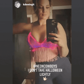 Close-up of pink light up fringe bralette with Instagram caption highlighting popularity at festival events and eye-catching fiber optic illumination