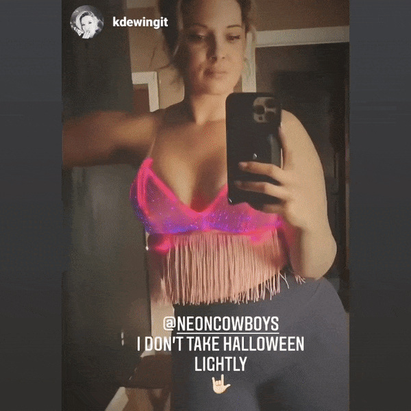 Close-up of pink light up fringe bralette with Instagram caption highlighting popularity at festival events and eye-catching fiber optic illumination