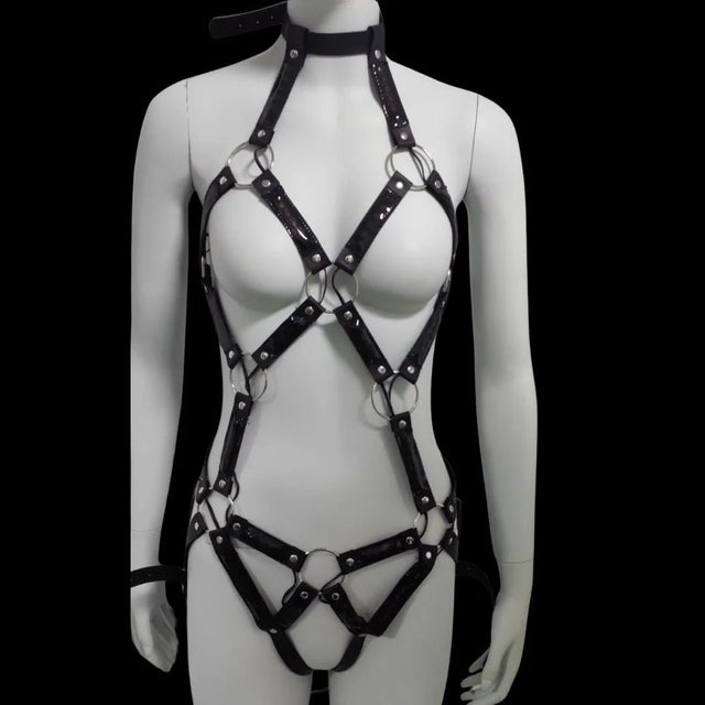 LED body harness with lights off — glossy black patent cage harness with silver O-rings, choker collar and thong-cut straps, a made-to-order body harness for rave, burlesque and stage.