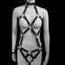 LED body harness with lights off — glossy black patent cage harness with silver O-rings, choker collar and thong-cut straps, a made-to-order body harness for rave, burlesque and stage.