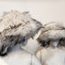 Woman wearing white furry bucket hat without LED illumination - Non-illuminated version showing soft polyester texture and natural daytime appearance for everyday fashion and casual winter wear
