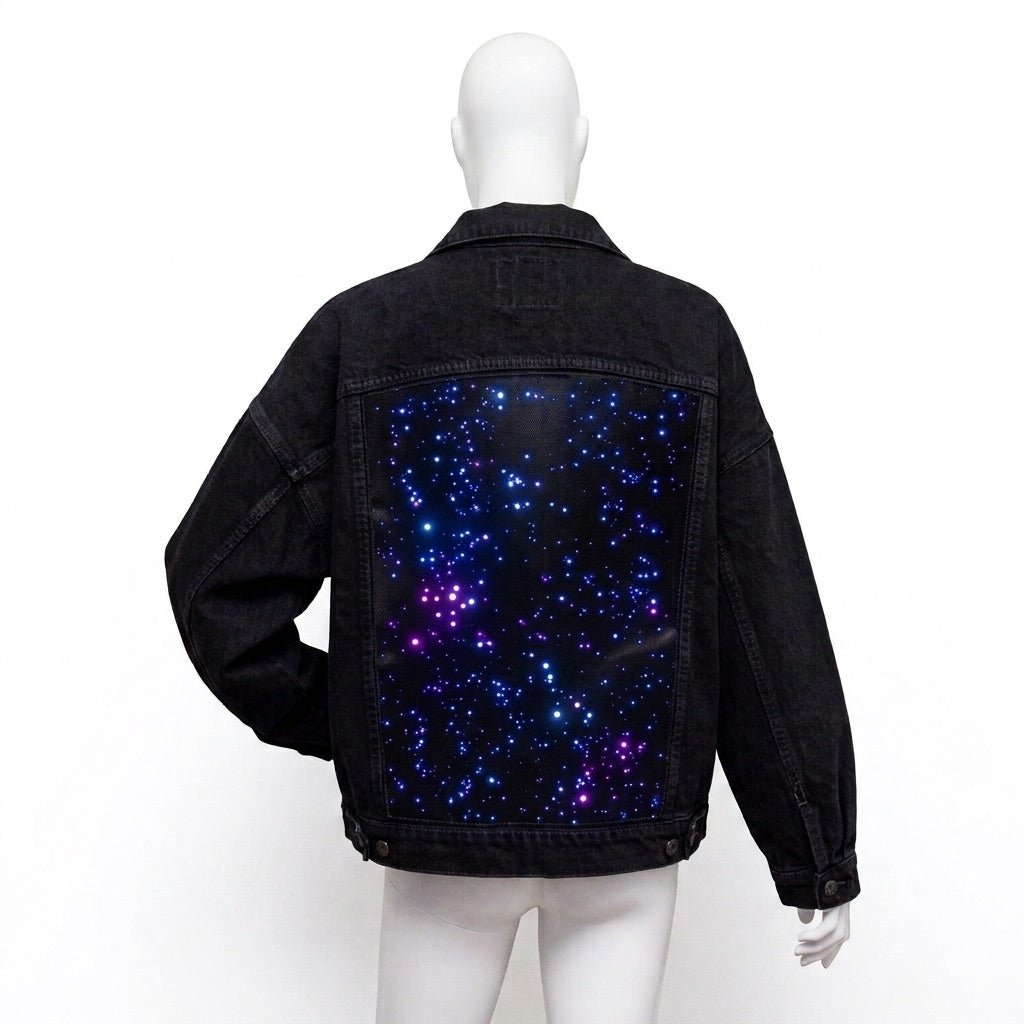 Black-wash Neon Cowboys Galaxy Denim Jacket back with an unlit blue and purple starfield print panel on a mannequin, a glowing led starfield light up denim jean jacket for music festivals and concerts, a space cowgirl and disco cowgirl statement piece for raves, Neon Cowboys