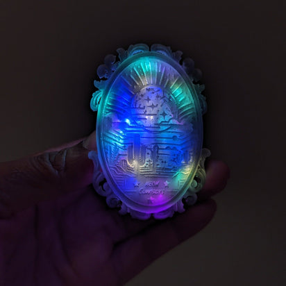 Multicolored LED bolo tie close-up against dark background - Detailed view of illuminated western accessory showing vibrant colors for costume contests, dance performances, and nighttime events