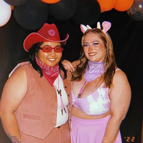 Two women in cowboy hats and bikinis posing together at country western themed festival demonstrating friendship outfit coordination for summer music events and themed pool parties